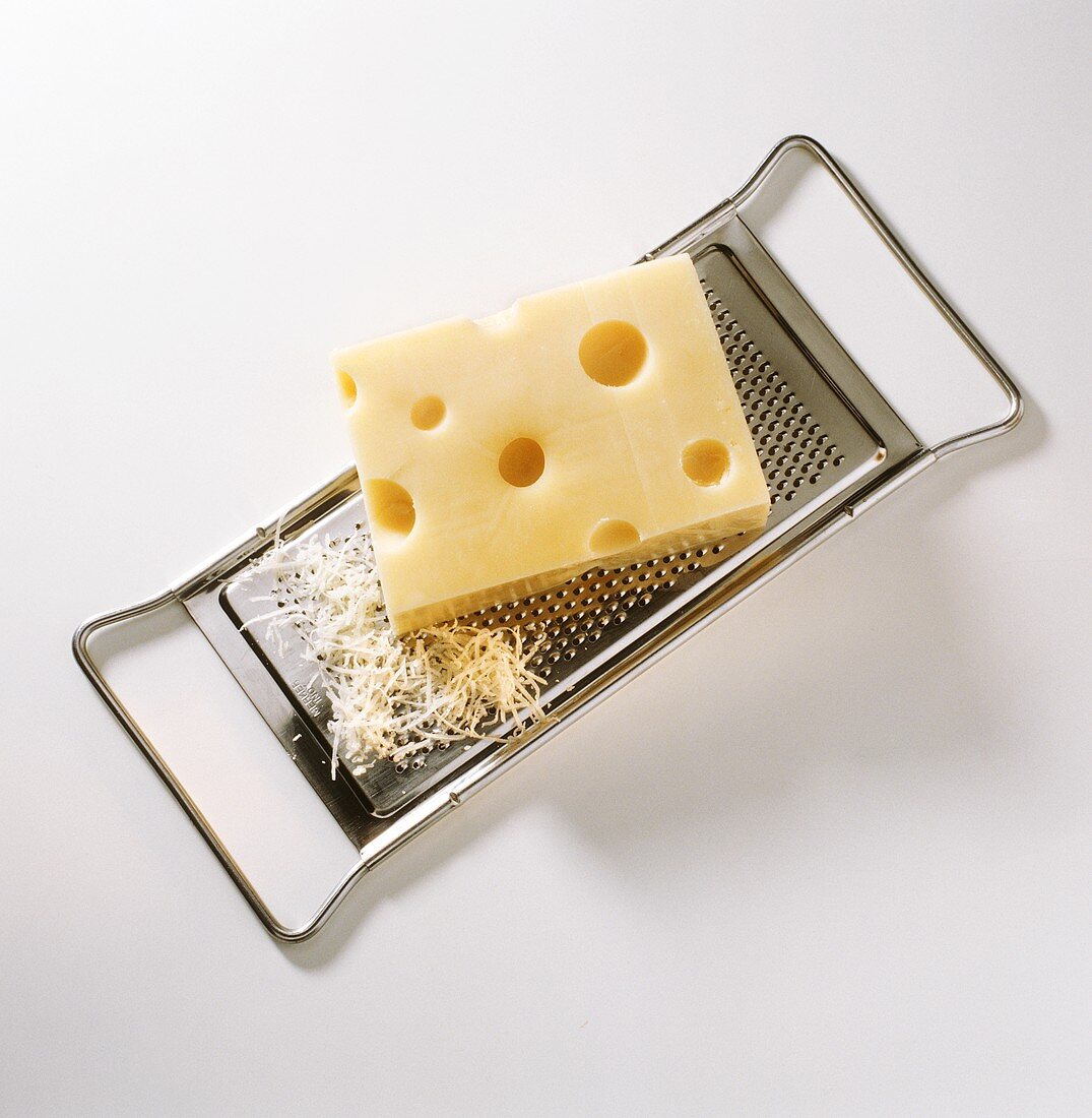 A piece of Emmental cheese on grater