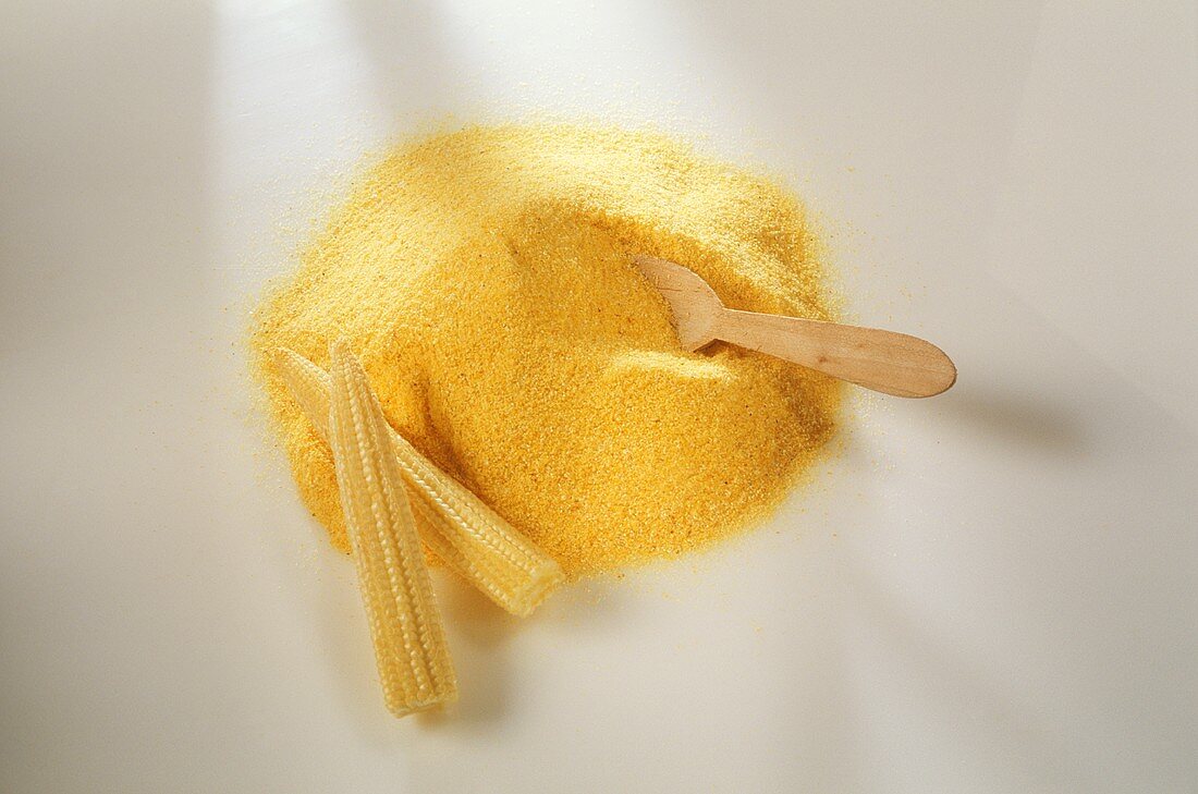 Polenta with wooden spoon and two small corncobs