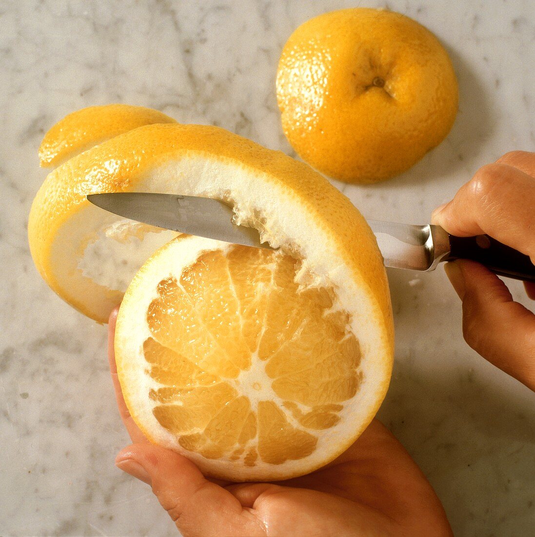 Peeling grapefruits with a knife