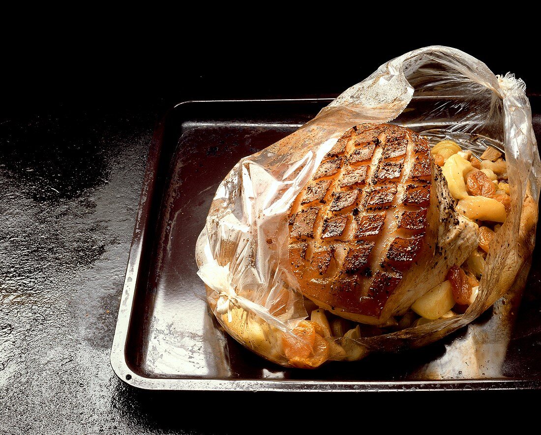 Pork roast in foil on baking sheet
