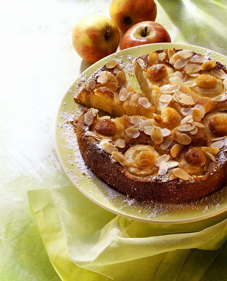 A baked apple cake and apples