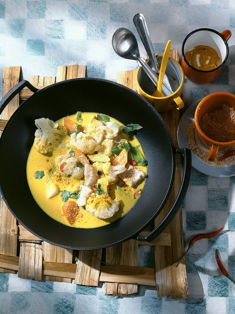 Fish curry with cauliflower in wok