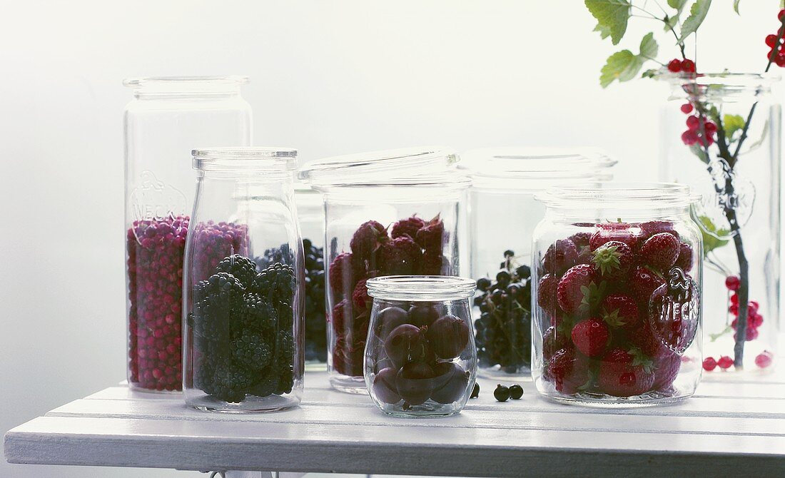 Fresh berries in bottling jars