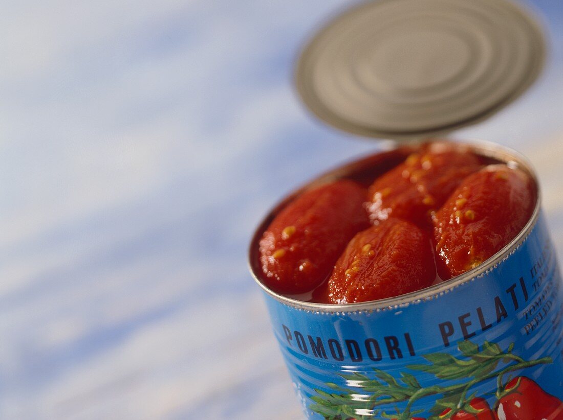 Peeled tomatoes in opened tin