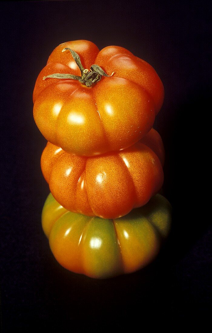 Three beefsteak tomatoes on top of each other