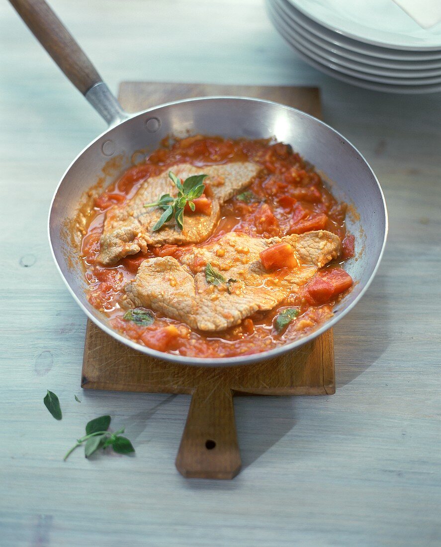 Kalbsschnitzel mit Tomatensauce in der Pfanne