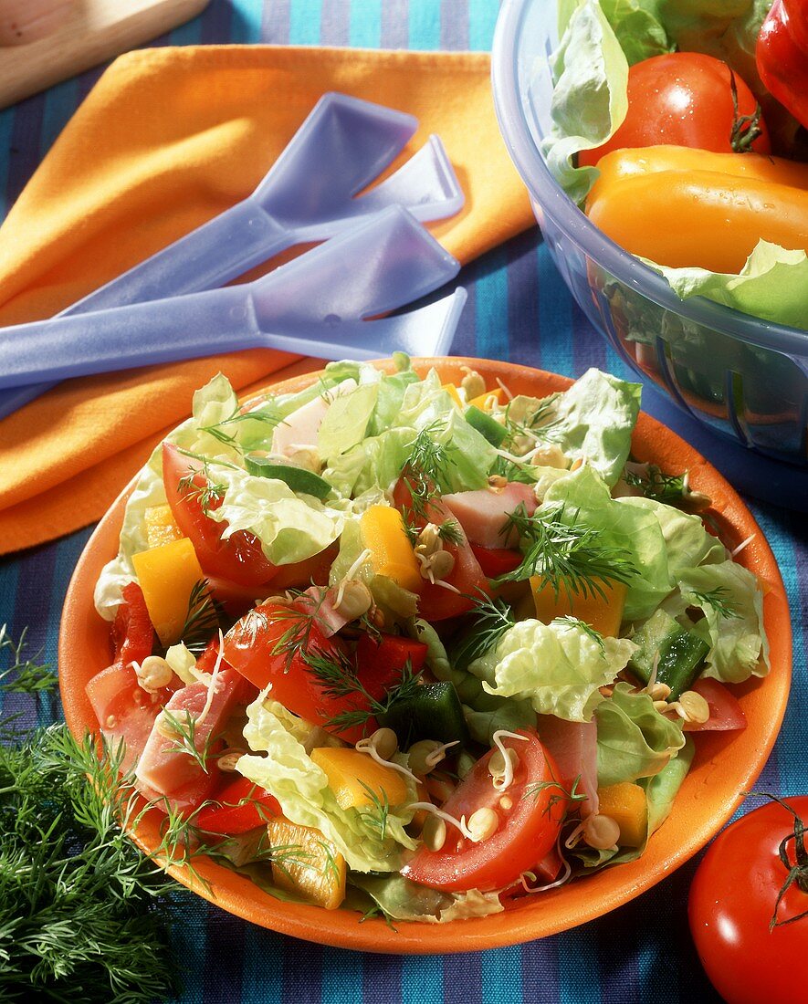 Salad leaves with peppers, tomatoes and ham