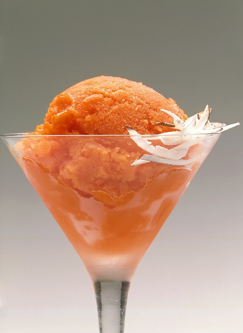 Papaya sorbet in ice bowl