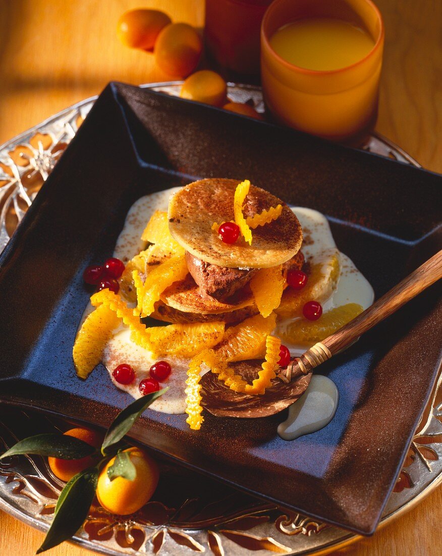 Puff pastry slices with mousse au chocolat and orange segments