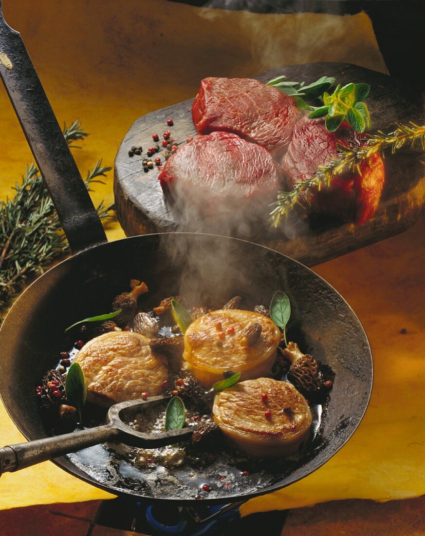 Beef tournedos with morels and sage in a frying pan