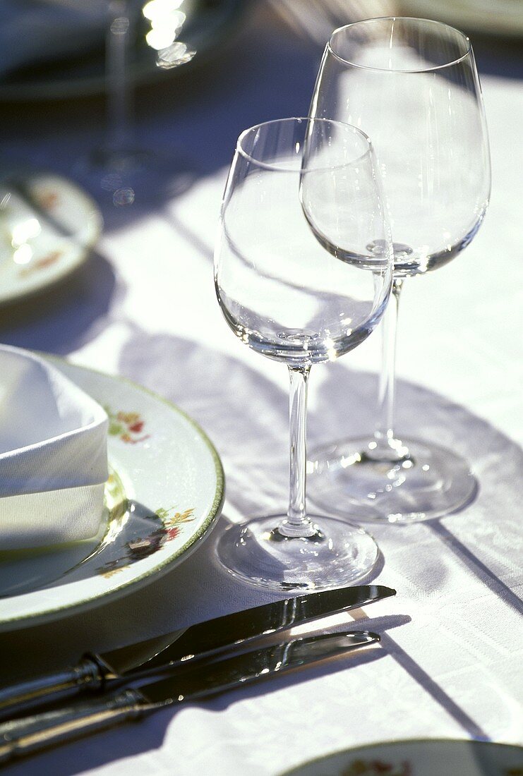 Two wine glasses on laid table