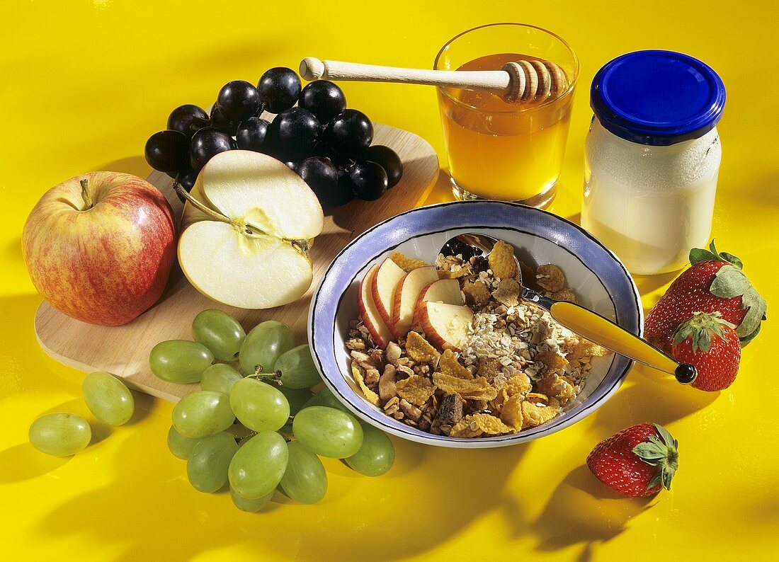 Muesli and ingredients: cereals, fruit, honey, yoghurt
