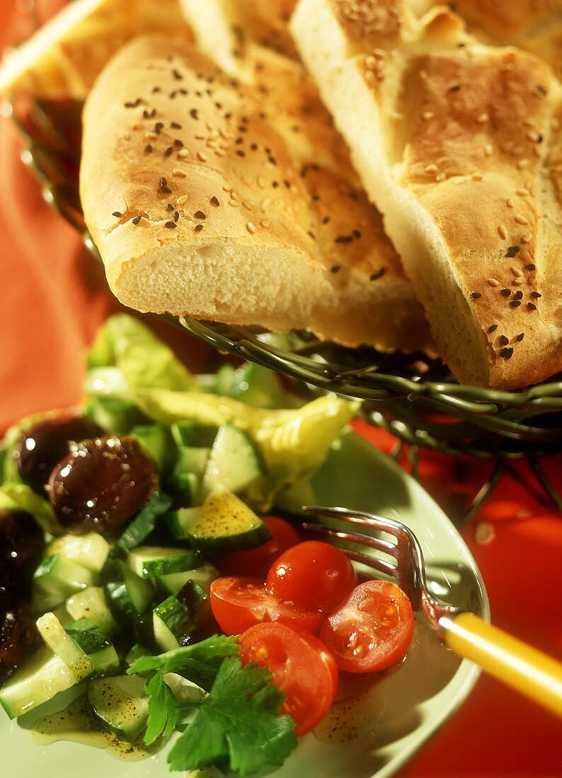 Mixed salad with cucumber, olives, tomatoes, with flat bread