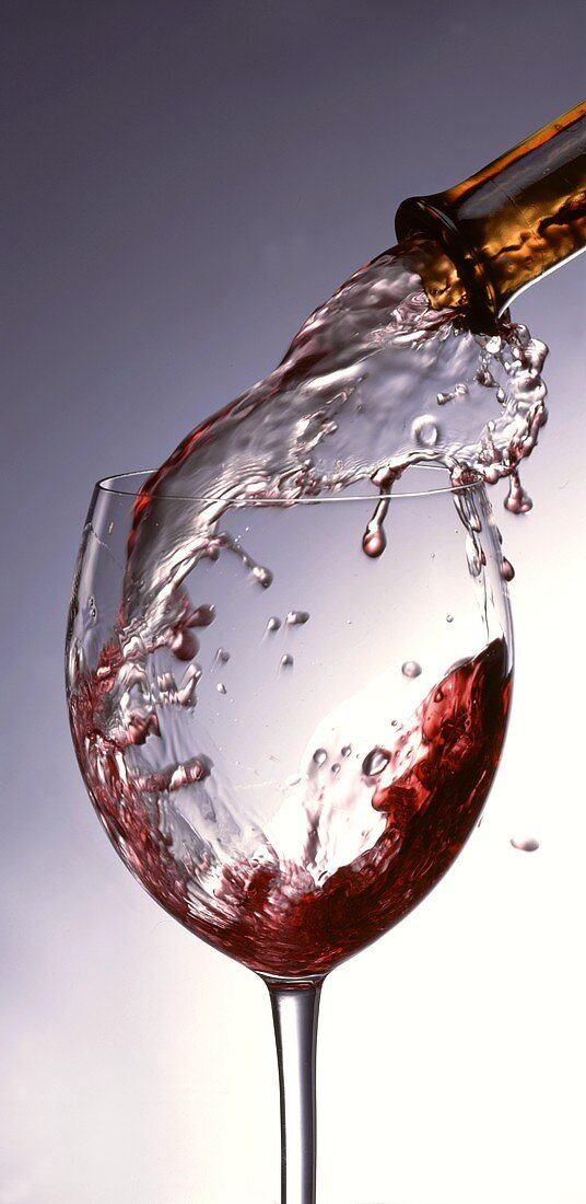 Red wine being poured into a glass