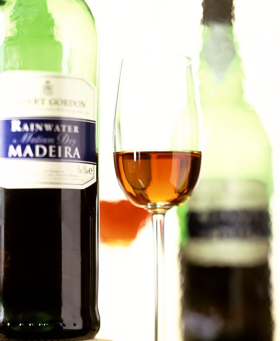 A glass of Madeira, bottle in background