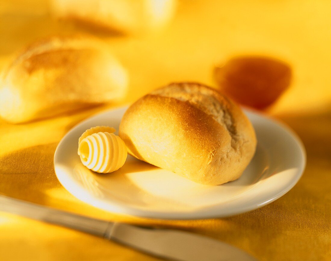 Roll with butter curl on a plate