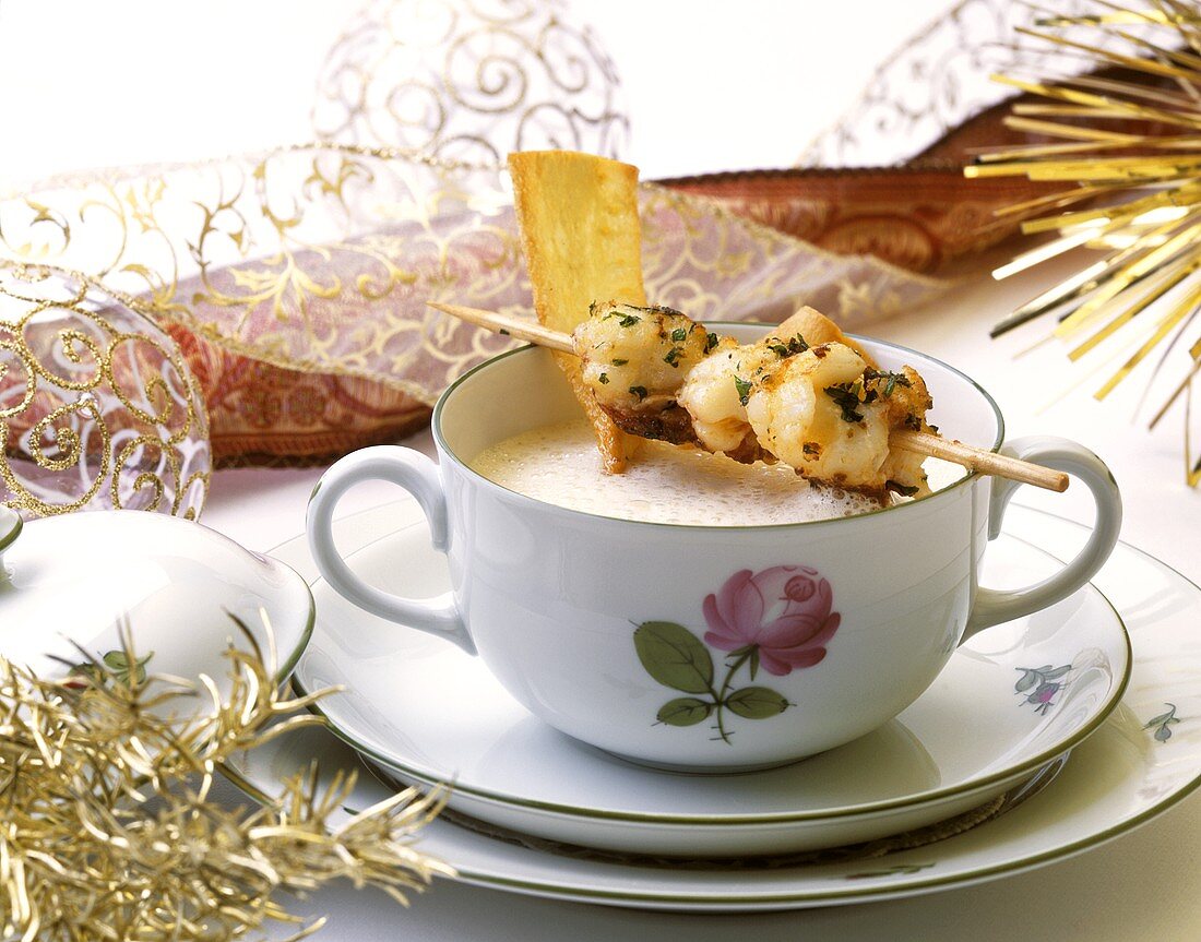 Creamed root vegetable soup with lobster kebabs