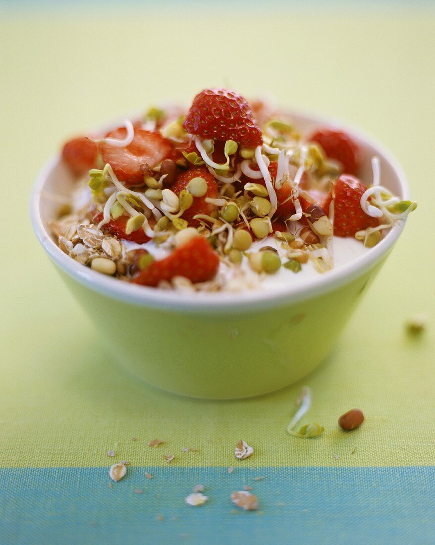 Muesli with yoghurt, sprouts and strawberries