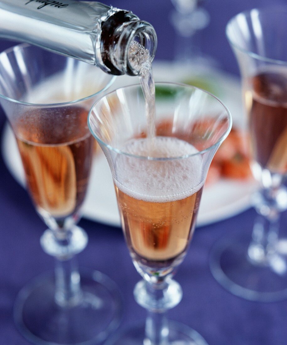 Pouring rosé champagne
