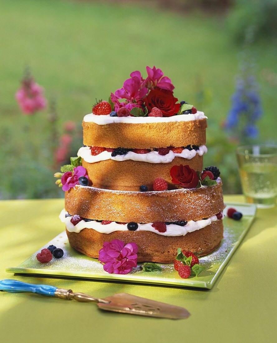 Tiered berry gateau garnished with flowers