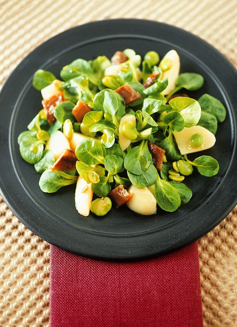Corn salad with broad beans, potatoes and anchovies