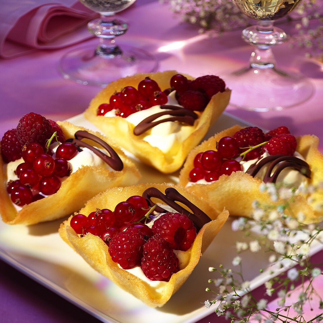 Fresh berries with vanilla cream in wafer bowls