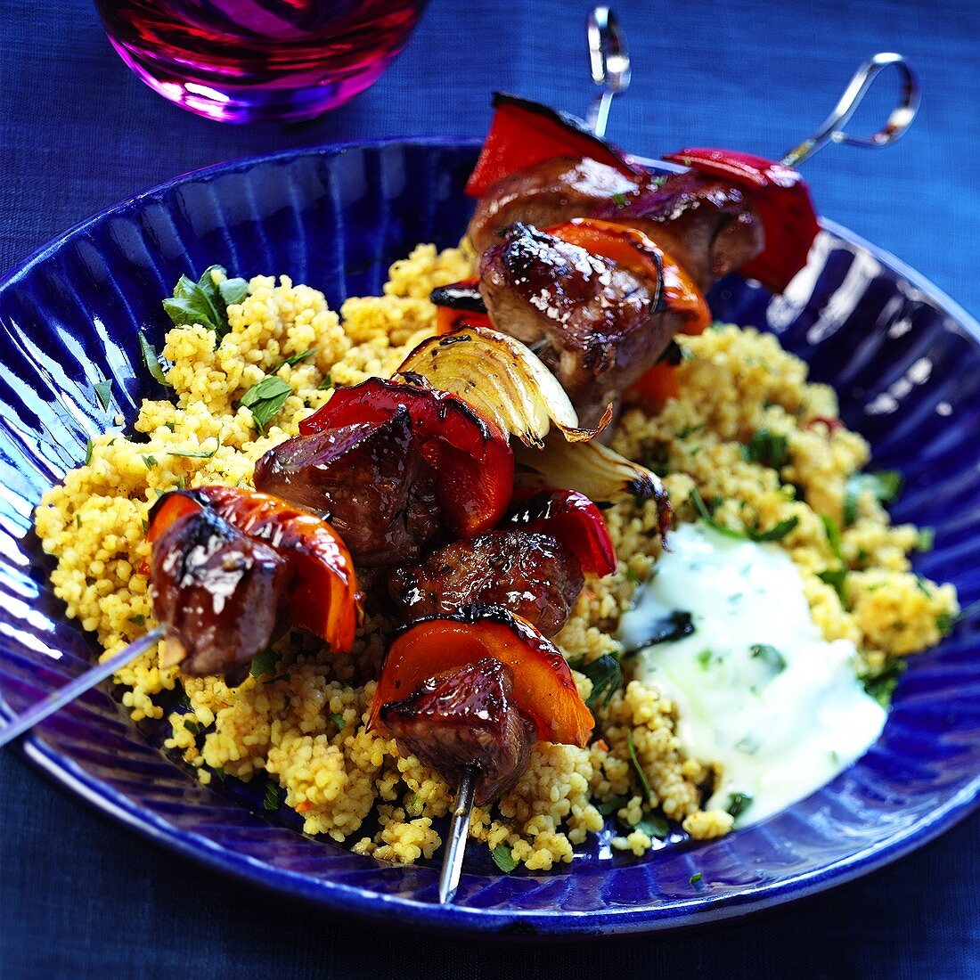 Grilled lamb kebabs on couscous