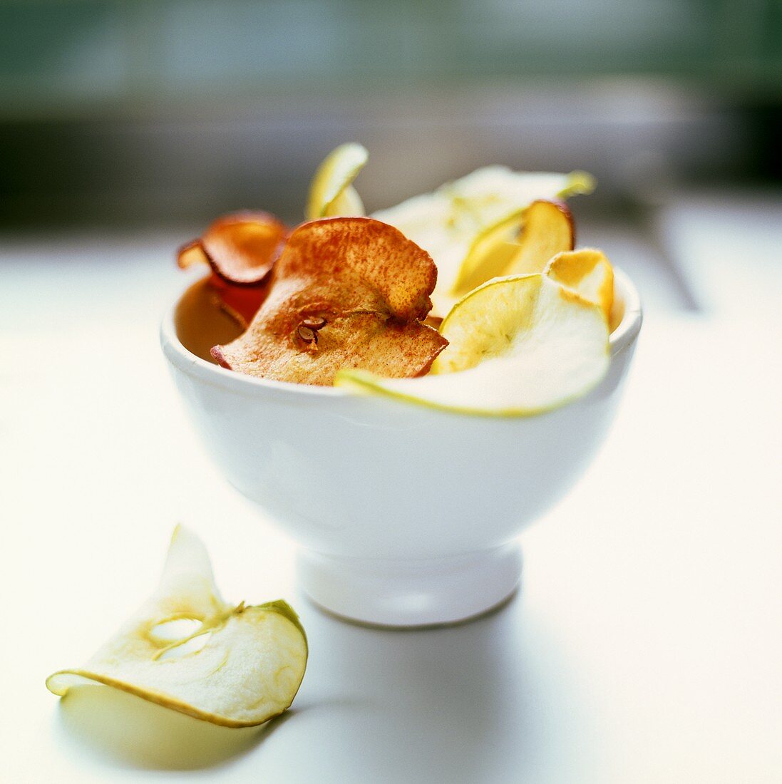Apple crisps (dried apple slices) in a bowl