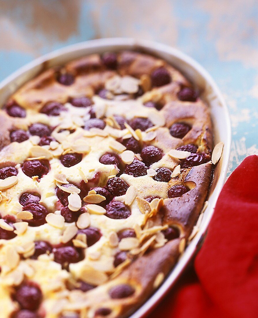 Sweet cherry pudding with flaked almonds