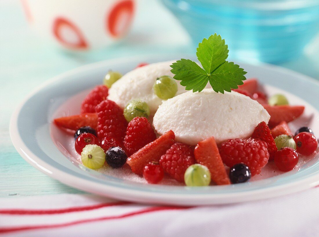 Yoghurt dumplings on fresh sugared berries