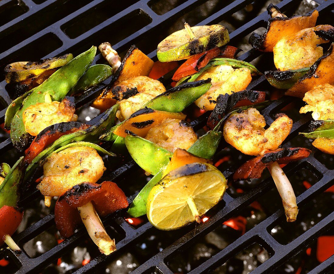 Scampi and vegetable kebabs on grill