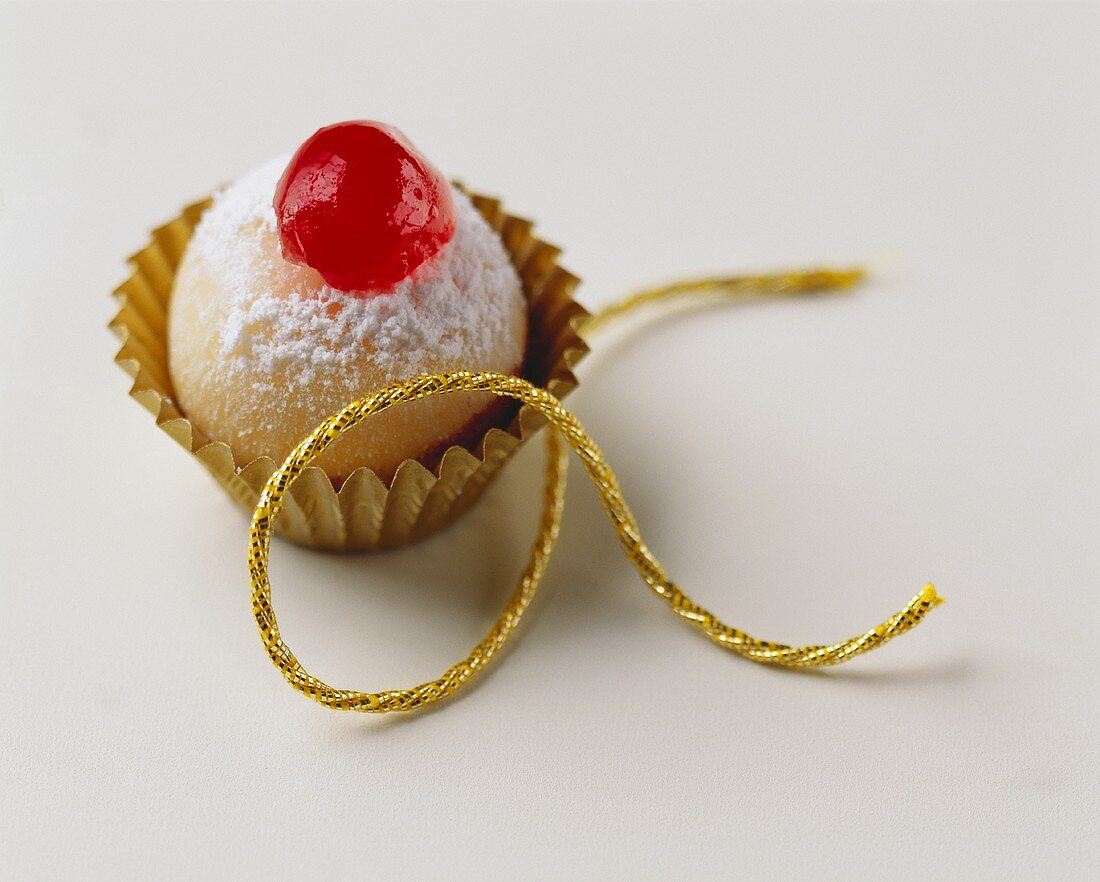 Marzipan ball, decorated with glacé cherry