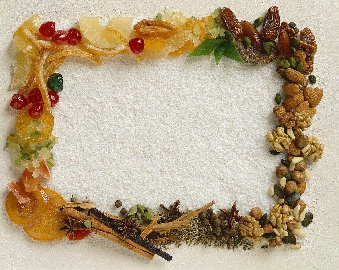 Frame of nuts, spices, fruits on grated coconut