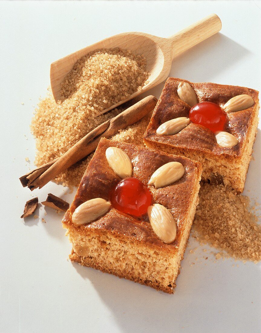 Two pieces of gingerbread, decorated with almonds & cherries