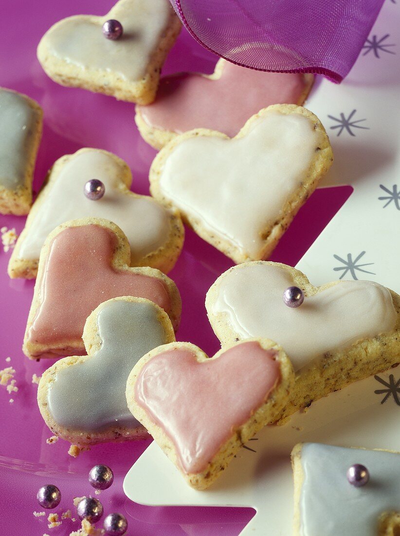 Hazelnut hearts with pastel-coloured icing
