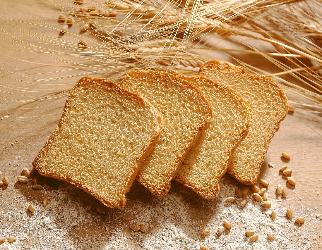 Four slices of zwieback (rusk) with ears & grains of corn