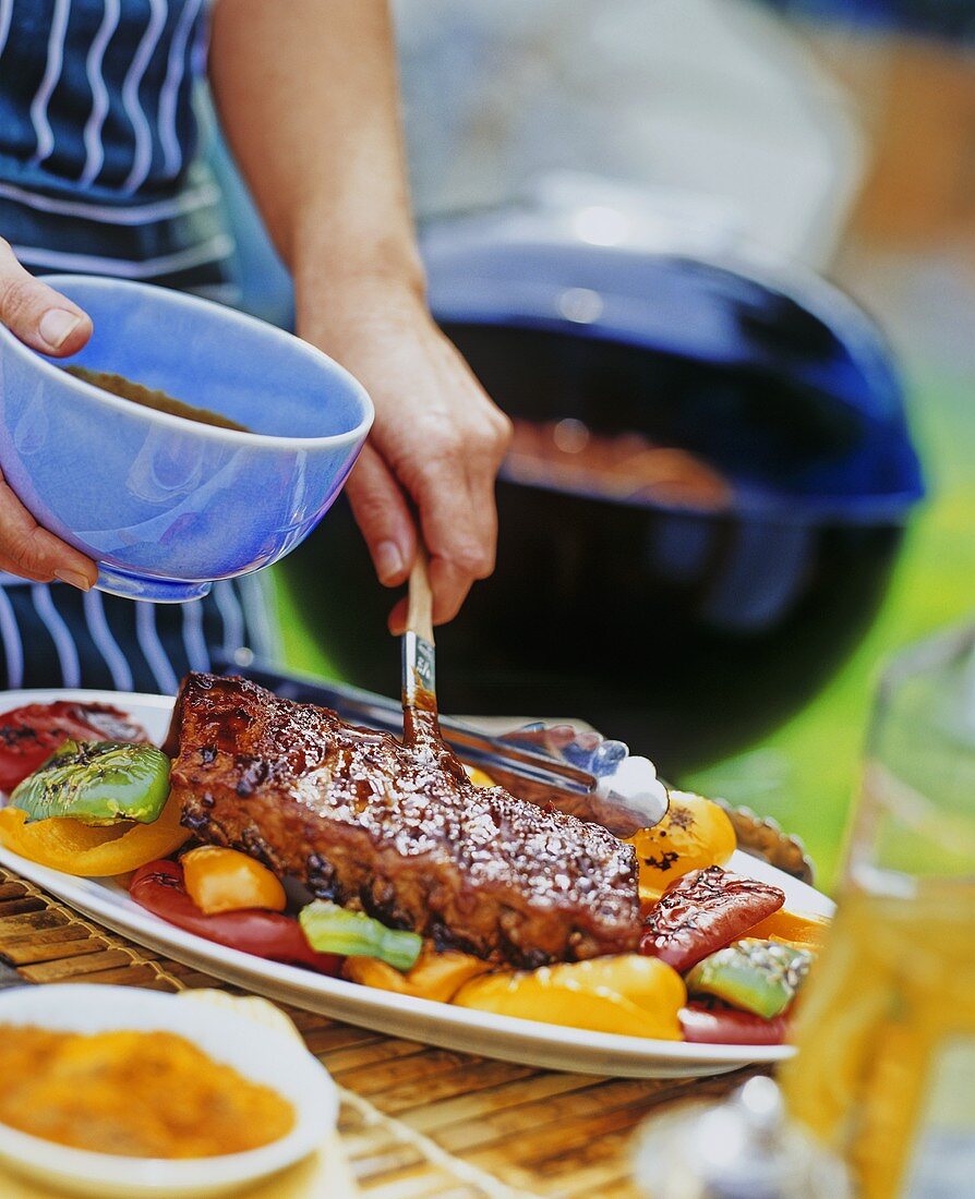 Brushing Ribs with BBQ Sauce