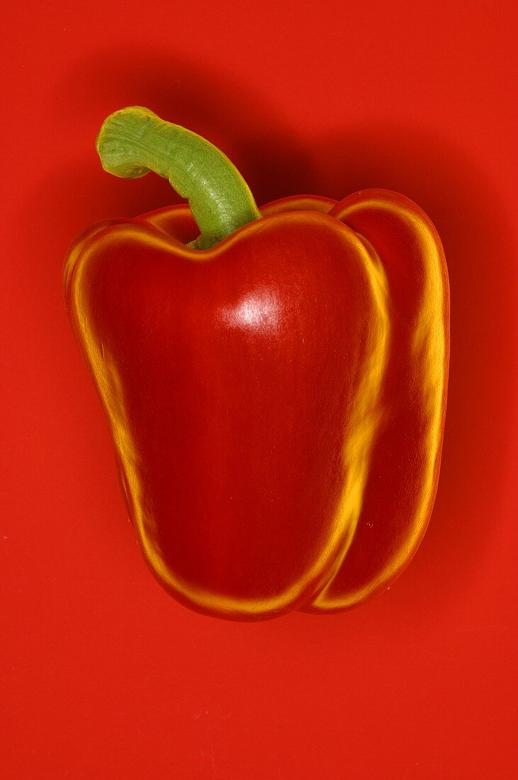 Red peppers against red background