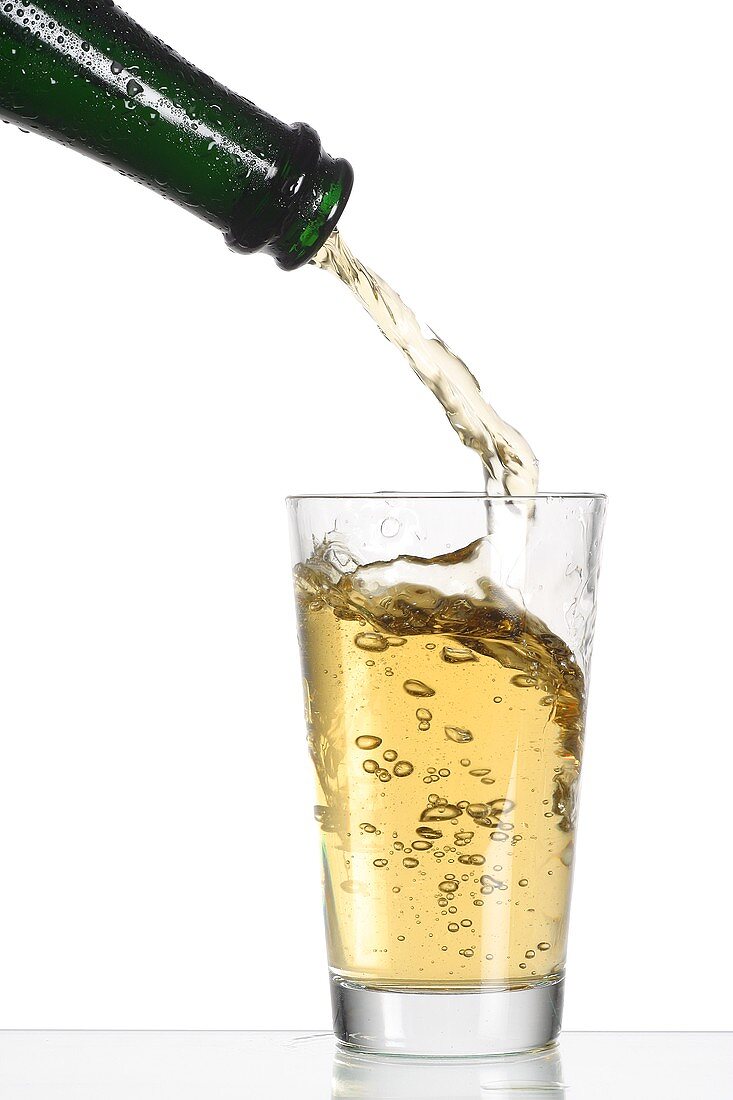 Pouring cider into a glass