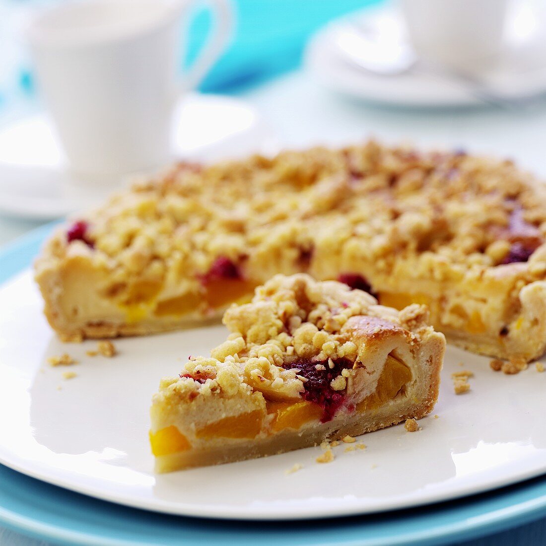 Peach crumble tart with raspberries