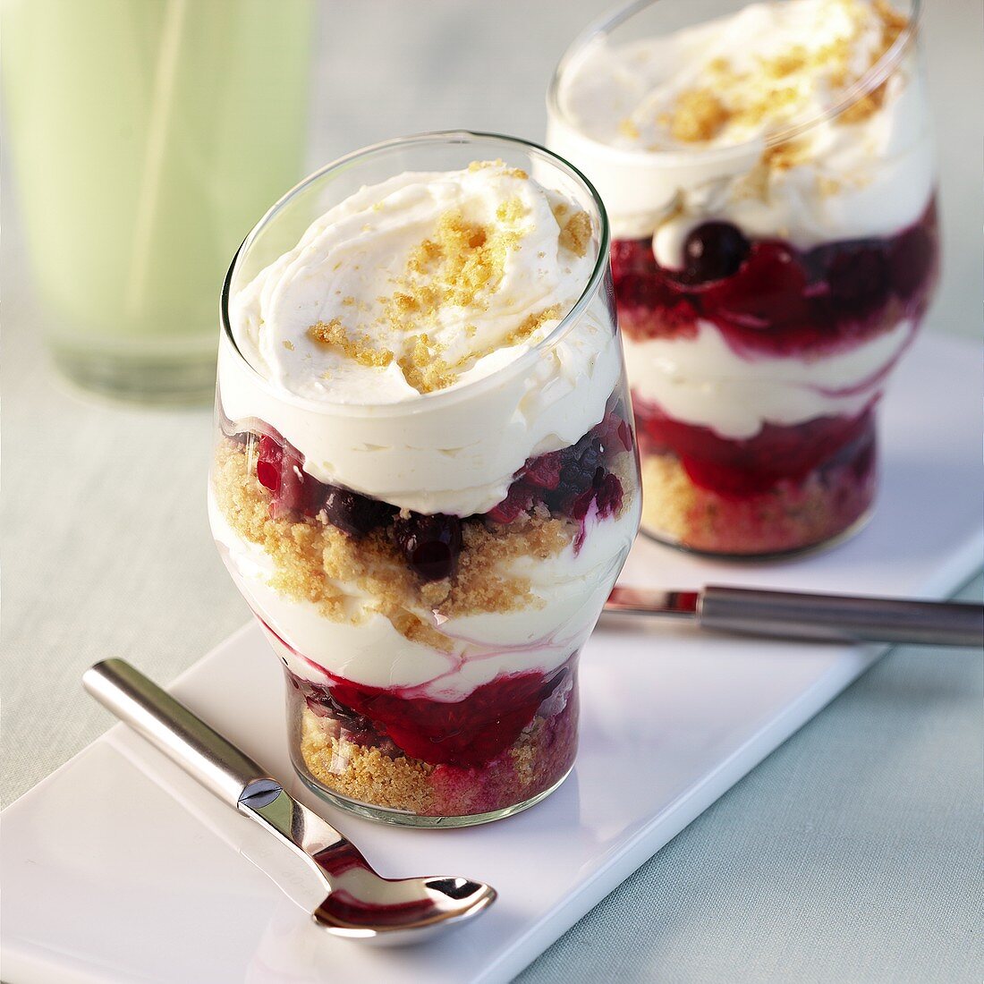Layered dessert with raspberry crumble and cream