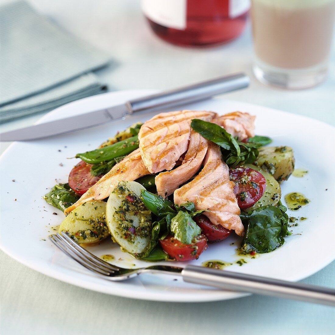 Salmon fillet on lettuce with herb dressing
