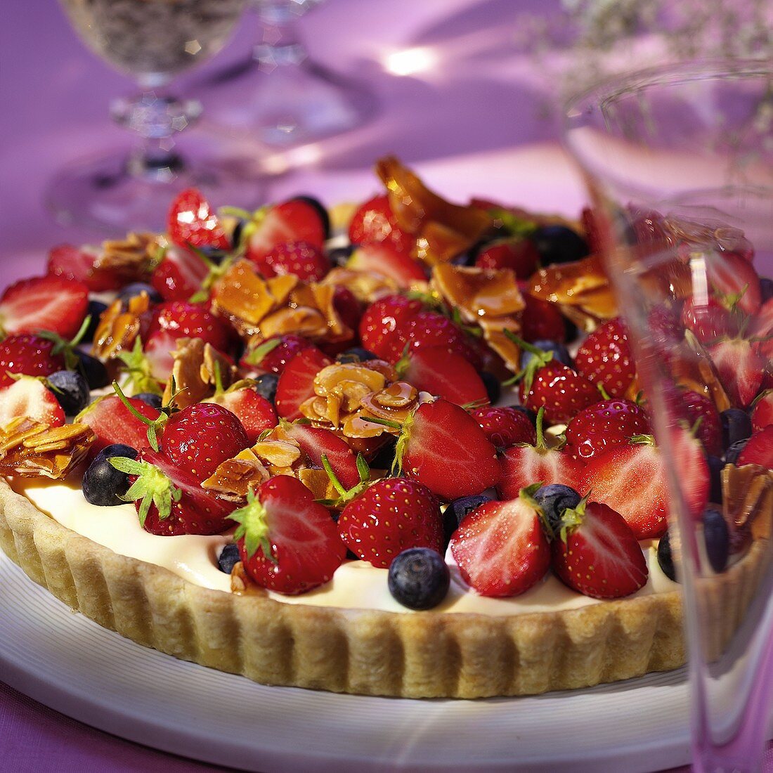 Strawberry and blueberry flan with vanilla cream & almonds