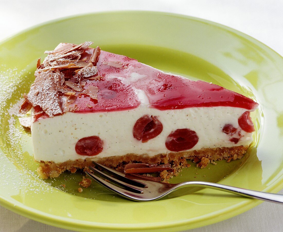 A piece of yoghurt cherry cheesecake with grated chocolate