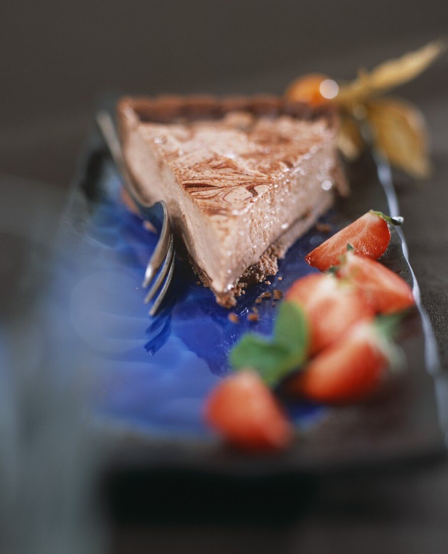 A piece of chocolate strawberry cream tart