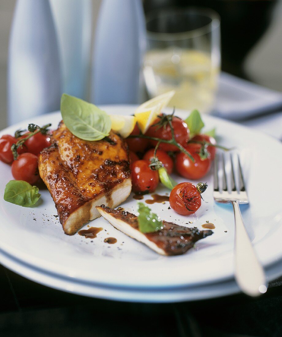 Barbecued marinated chicken breast with cocktail tomatoes