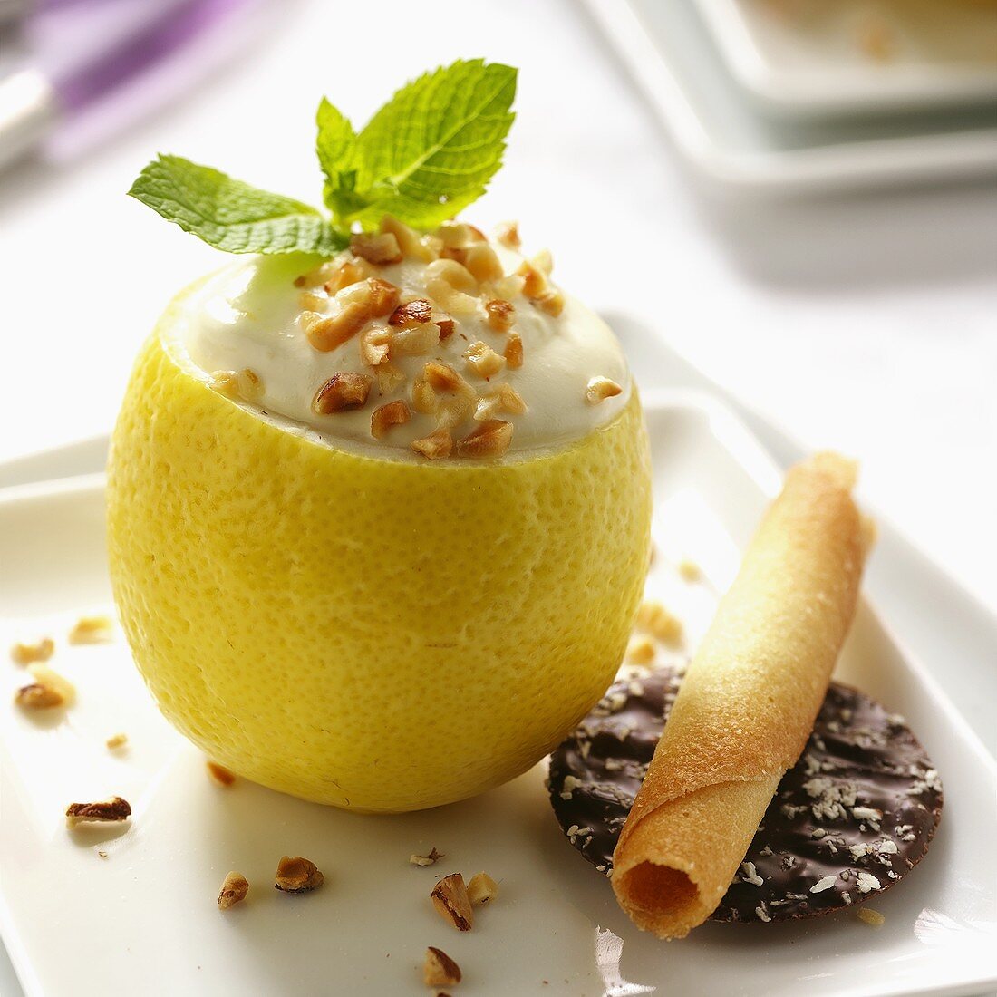 Lemon mousse with almonds in hollowed out lemon