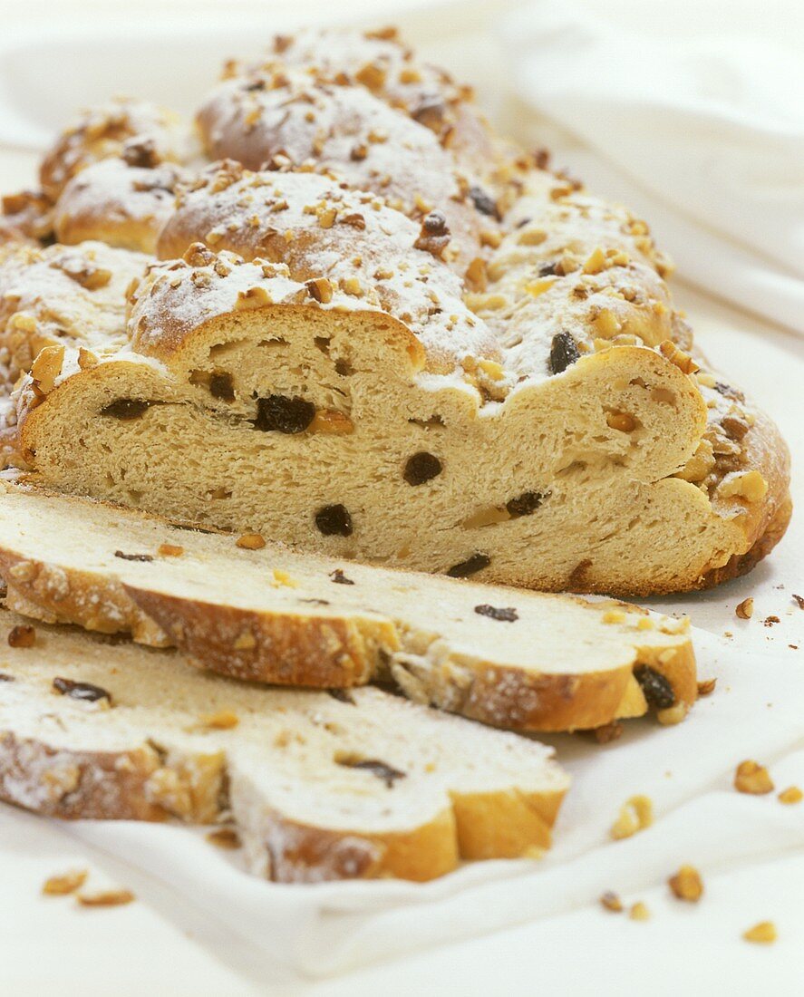 Christmas stollen with raisins and nuts, a piece cut
