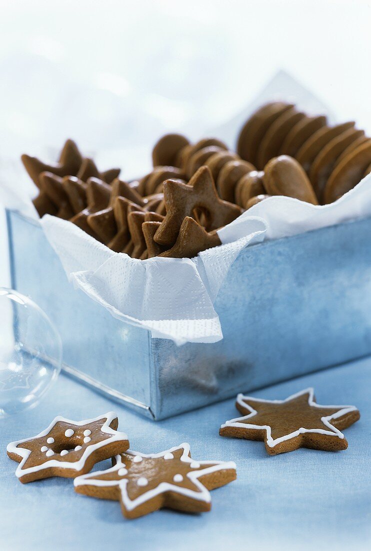 Gingerbread stars in and in front of a metal box