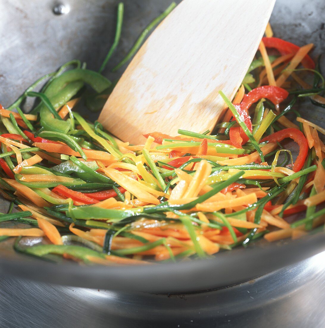 Frying vegetables in wok (stir-frying)